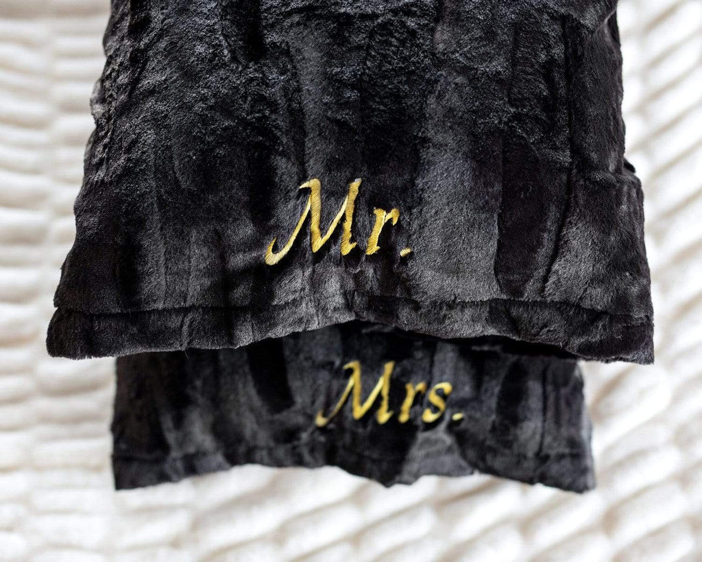 Black plush pillowcases by Minky Couture embroidered with Mr. and Mrs. in gold font. .