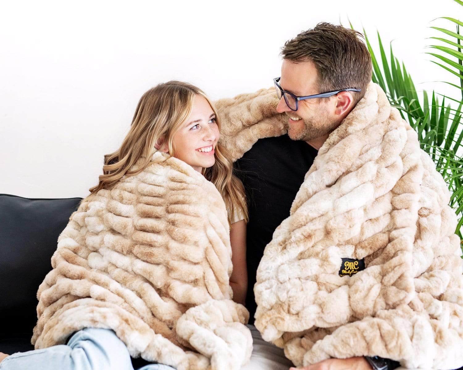Father and daughter snuggled up in Minky Couture's Cotton Candy Caramel Hugs blanket. 