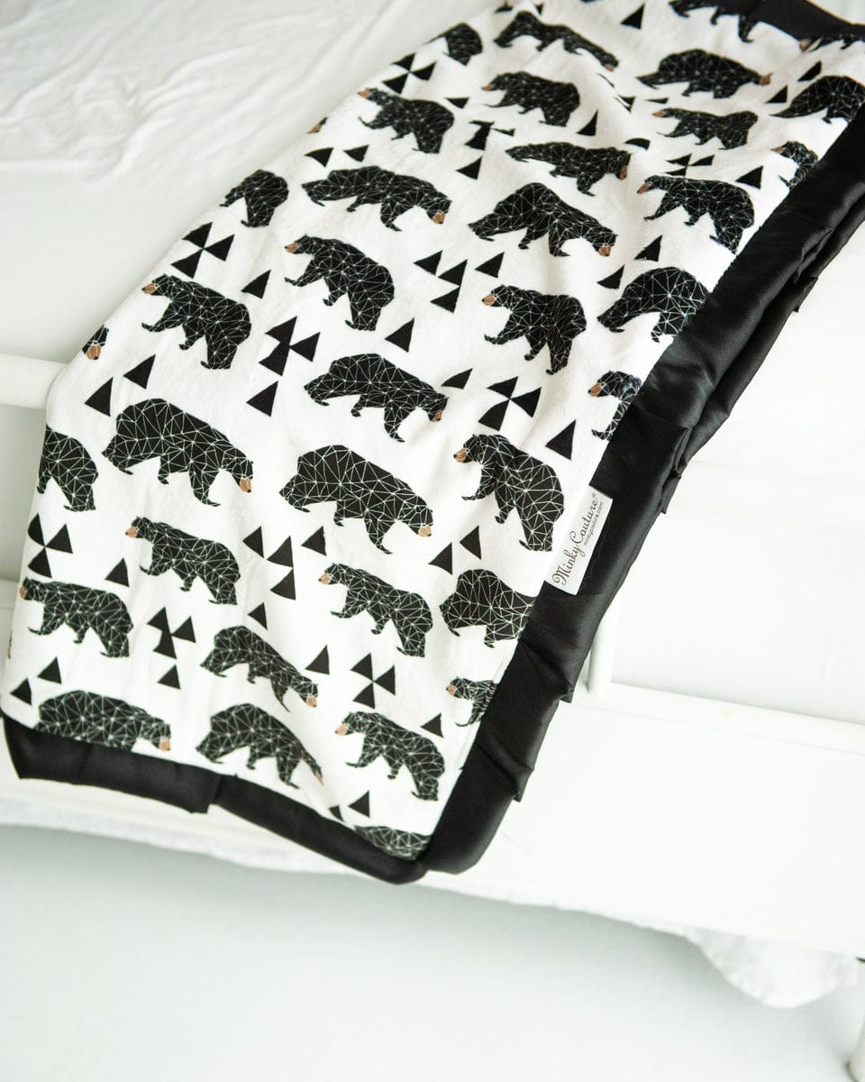 Black and cream bear patterned blanket with triangle accents. 