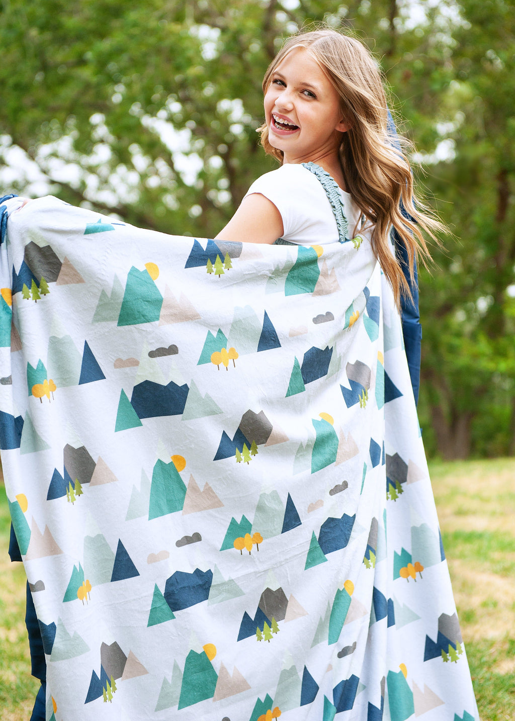 Girl twirling with a mountain top themed blanket by Minky Couture 