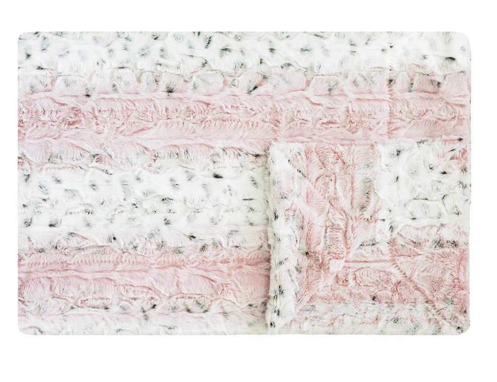 Pink Sandra blanket laid flat to show details and texture. Features pink and neutral colors with subtle animal print tones. 
