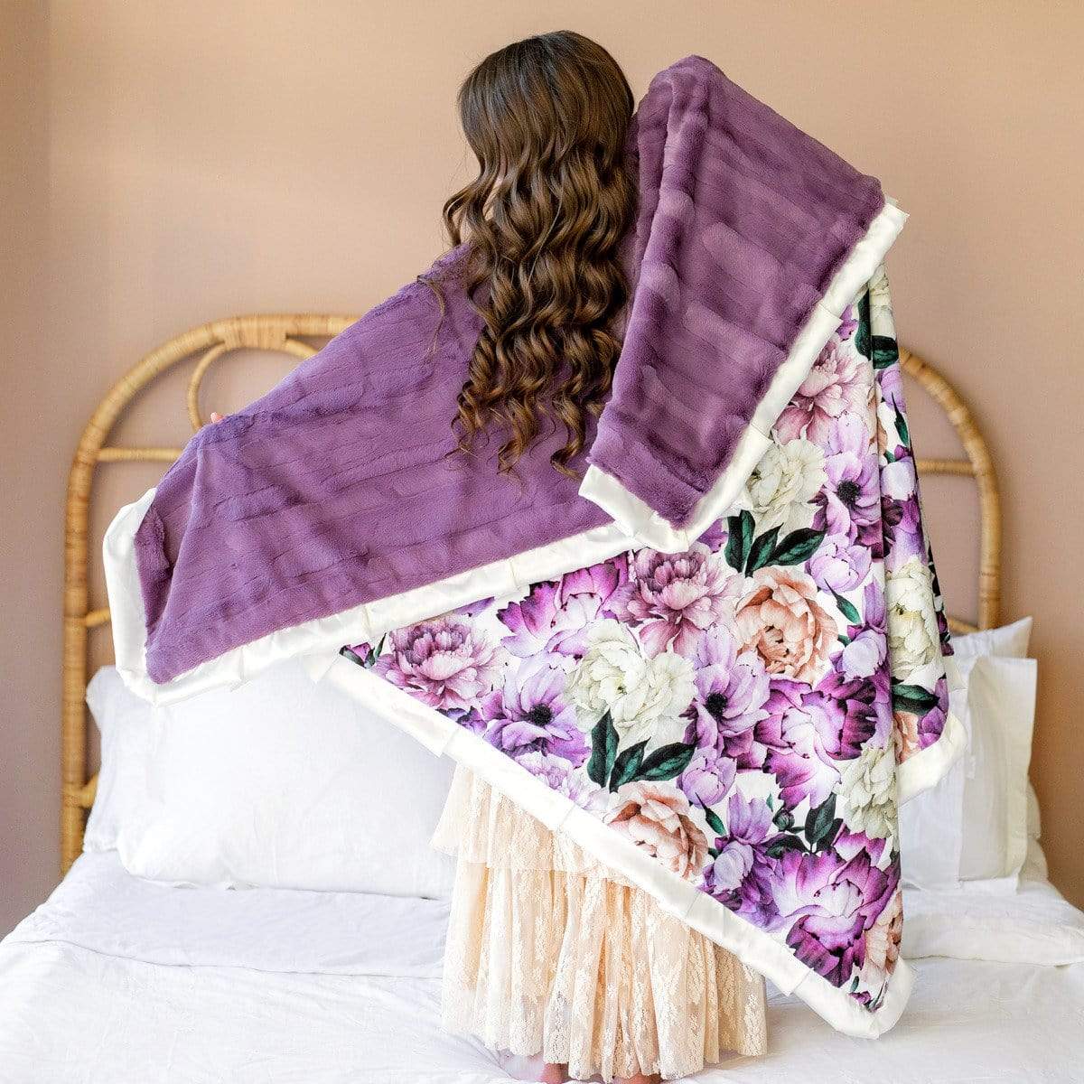 Girl standing with the Purple Promise blanket by Minky Couture across her back.