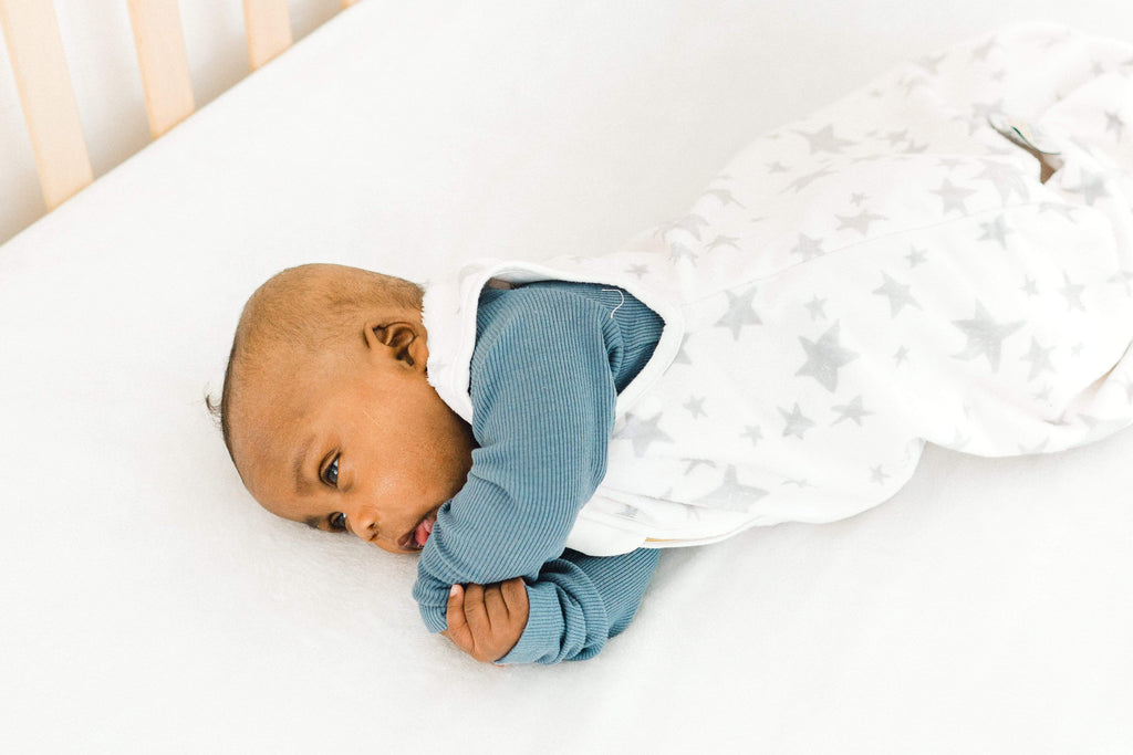 Baby boy in a silver star minky sleep sac by Minky Couture and Little Couture.