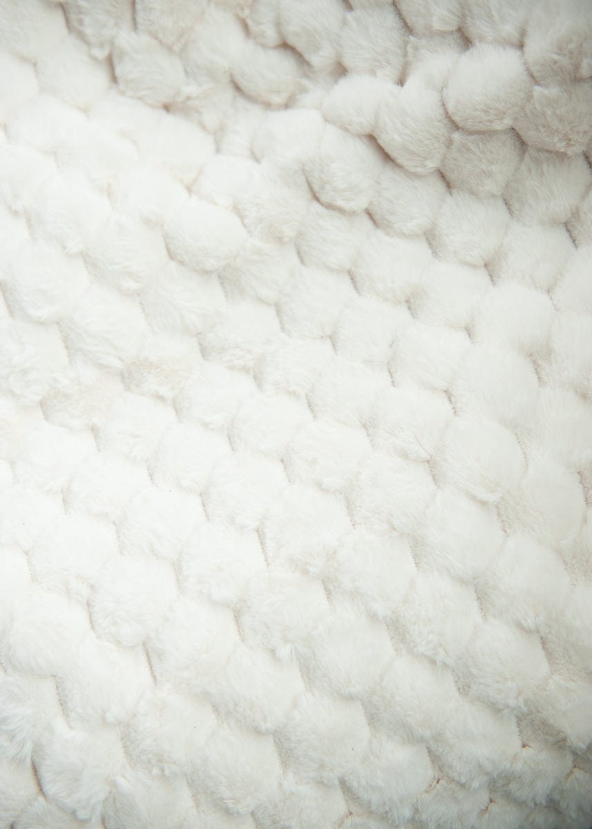 Cream waffle textured blanket.